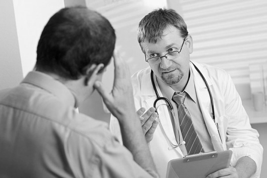 a doctor consulting with a patient about health symptoms